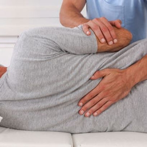 Medical professional helps man with injured back